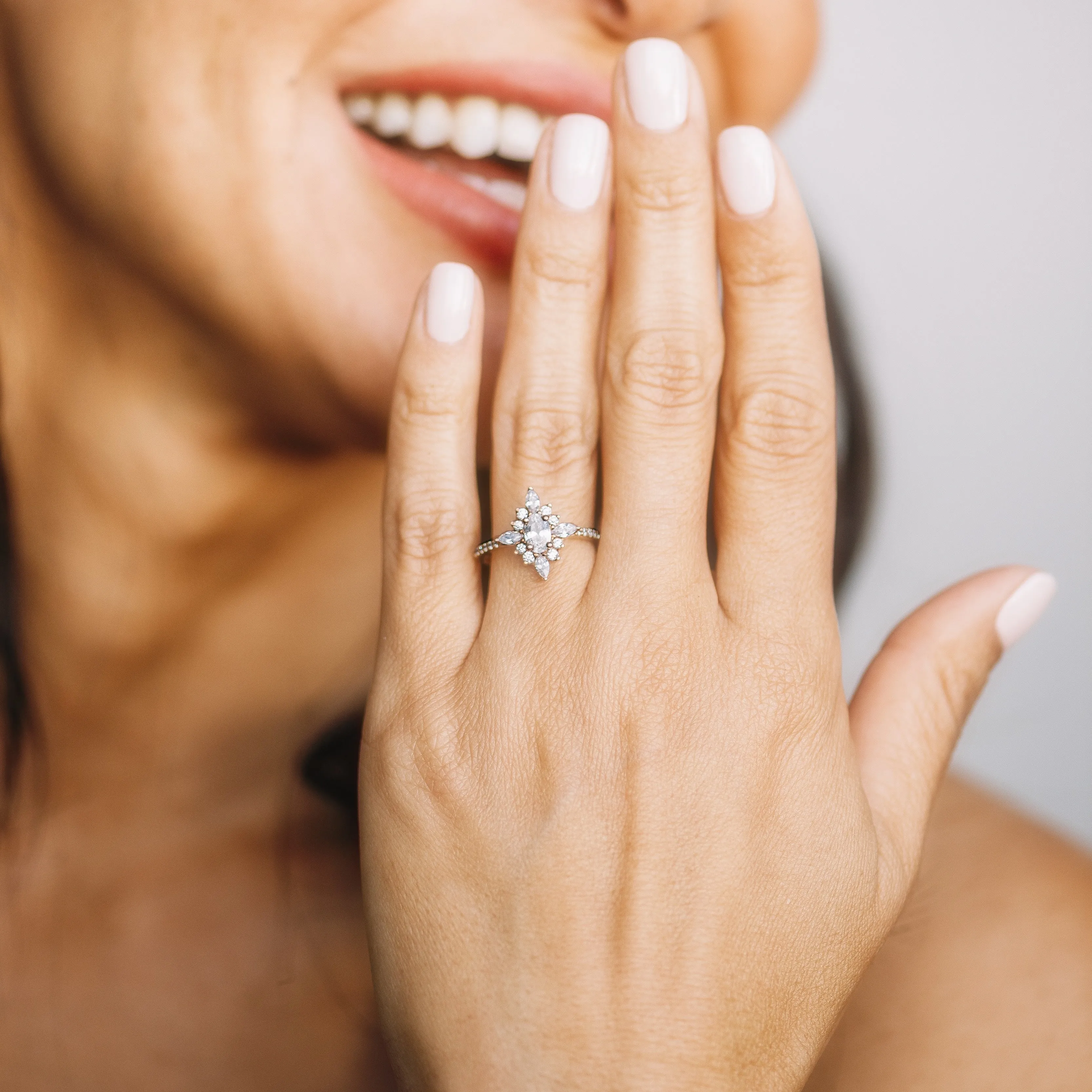 Oval Diamond and Starburst Flower Halo Engagement Ring